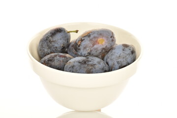 Several ripe organic Damson plums, close-up, isolated on white.