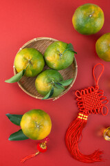 Top view of fresh tangerine mandarin orange on red background for Chinese lunar new year.