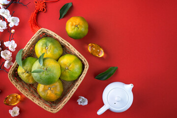 Top view of fresh tangerine mandarin orange on red background for Chinese lunar new year.