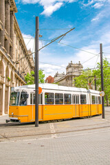 Yellow tram in Budapest - Public transport in Hungary. Old streets of capital city