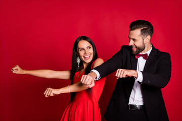 Photo of funky optimistic couple dancing wear suit dress isolated on red color background