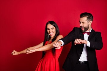 Photo of funny optimistic couple dancing wear suit dress isolated on red color background