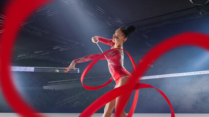 Rhythmic gymnast in professional arena.