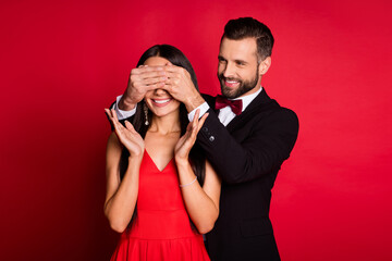 Photo of nice couple man close girl eyes wear suit dress isolated on red color background