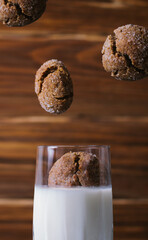 Сlose up view of glass of milk with cookies on wooden background.  Levitation cookies. 