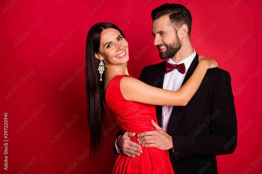 Sticker Photo of nice couple dance hug wear suit dress isolated on red color background