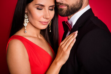 Cropped photo of optimistic couple dance closed eyes wear suit dress isolated on red color background