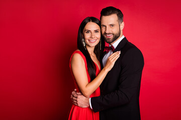 Profile photo of optimistic cute couple hug look wear suit dress isolated on red color background