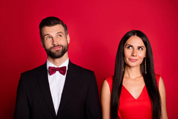 Portrait of pretty couple look up wear suit dress isolated on red color background