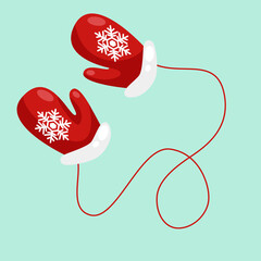 Red mittens with snowflakes isolated on a blue background.  Colored mitten. Snowflake icon. Vector illustration.