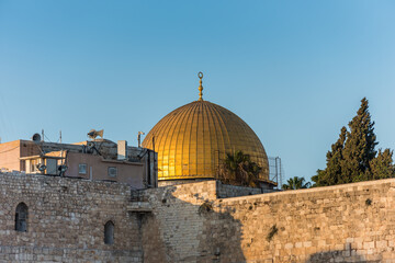 Fototapeta na wymiar Close-up of Golden Dome of the Rock, Qubbat al-Sakhrah, under sunset on Temple Mount of Old City of Jerusalem, Israel. One of the oldest extant works of Islamic architecture