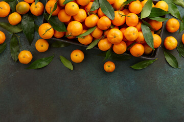 Fresh mandarin oranges with leaves, copy space. Seasonal winter fruits for Christmas.