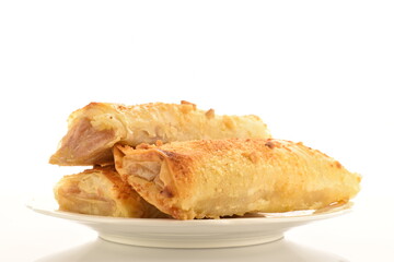 Homemade apple mini strudel, close-up isolated on white.