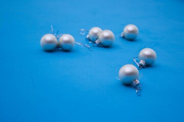 Small christmas silver balls on blue background