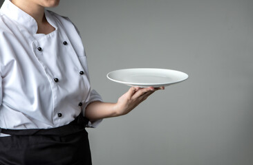 chef present food with white empty plate