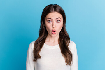 Fototapeta premium Photo of charming shocked curly woman dressed white pullover big eyes isolated blue color background