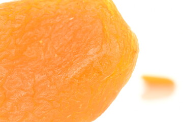 Bright orange natural dried apricots, close-up, isolated on white.