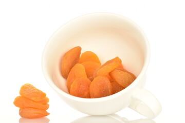 Bright orange natural dried apricots, close-up, isolated on white.