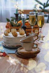 Christmas and celebration with tangerines, champagne and homemade cake. New Year holiday decorated table