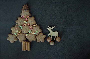 Christmas tree made of cinnamon sticks star anise decorated with colored candied pineapples