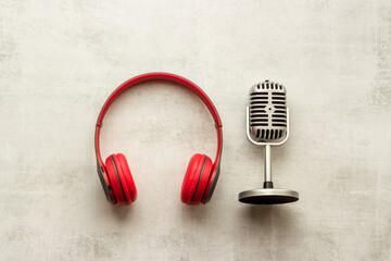 Recording background. Microphone and headphones on table, top view