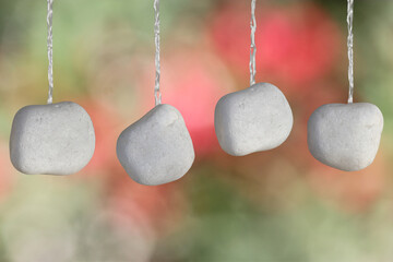 Four Hanging pebbles with copy space for text.
