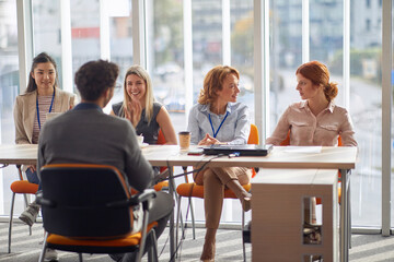 A young male applicant sitting in front of company commission at an interview. People, job,...