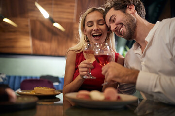 A young couple in love toasting at Valentine's day celebration in restaurant. Together, Valentine's day, celebration