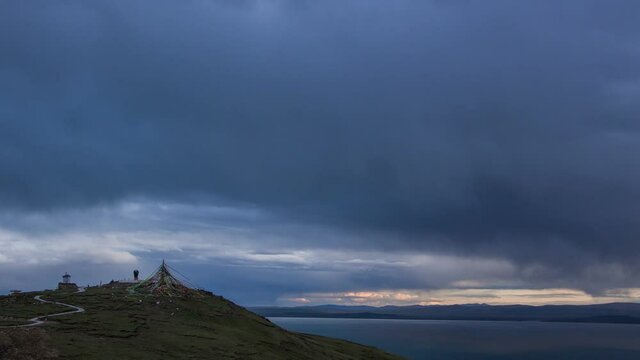 Scenic tibetan highland landscape with buddhist stupa, cumulus clouds and mountains. Source of Yellow River (Huang He). Tibetan Plateau in Qinghai Province, Amdo region, China. 4K UHD timelapse.