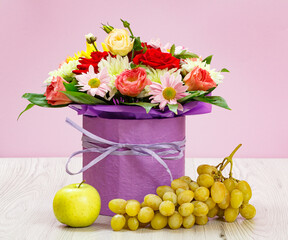 Bouquet of wildflowers and fruits on wooden boards.