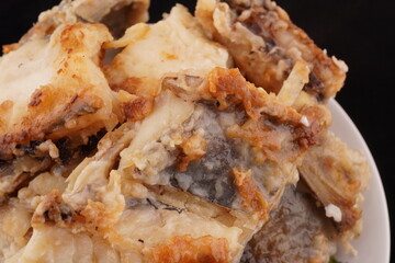 fried fish on a black background
