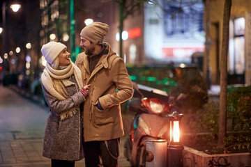 A young happy couple on the sidewalk. Relationship, together, Xmas