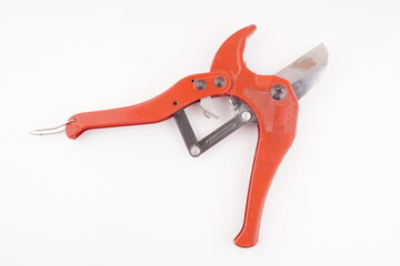 red knife for plastic pipes on a white background
