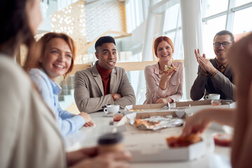 A group of employees at a break enjoying chatt and food at company's canteen. People, job, company, business concept.