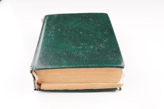 old green dictionary on white background