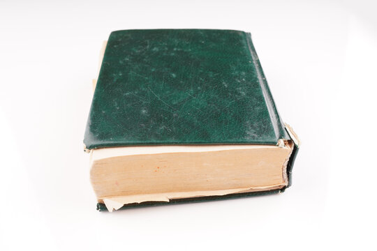 old green dictionary on white background