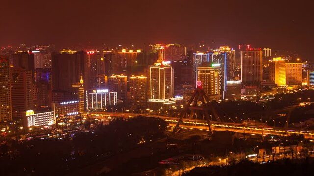 Xining, Qinghai province, China - JULY 11, 2016: Neon shining cityscape at night. 4K UHD timelapse.