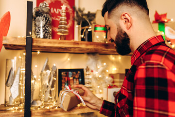 Christmas young man, with a Christmas present at home in a Christmas interior, Christmas