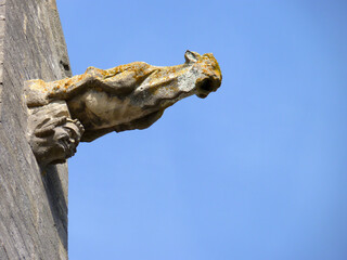 Ruined statue coming out of an old building's corner