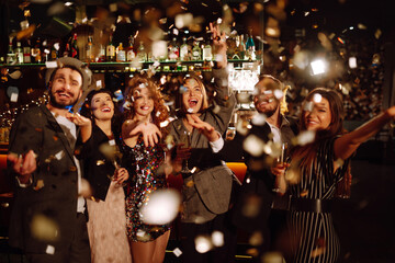 Confetti party. Have fun together. Group of happy people throwing confetti while enjoying party....