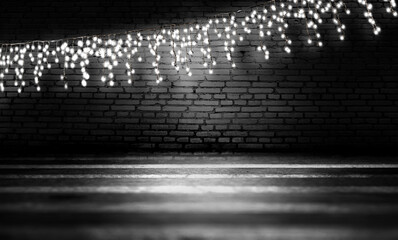 Light garland on a dark brick wall. Reflection of lights on the asphalt. Neon light, smoke, smog. 3d illustration