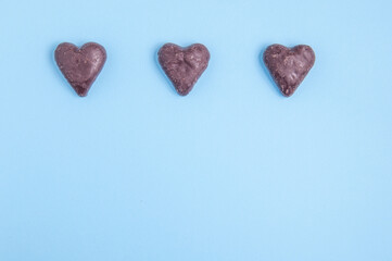 heart shaped chocolates on blue background