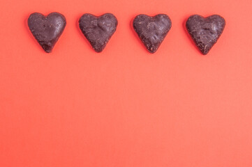 heart shaped chocolates on red background