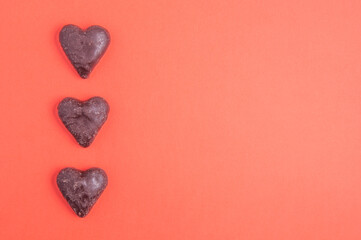 heart shaped chocolates on red background