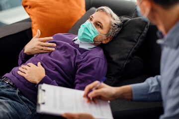 Distraught man talking about his mental health problems with a counselor during COVID-19 pandemic.