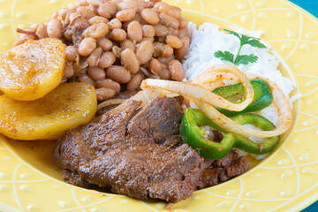 Brazilian lunch food dish on yellow dish.