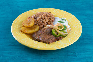Brazilian lunch food dish with blue background.