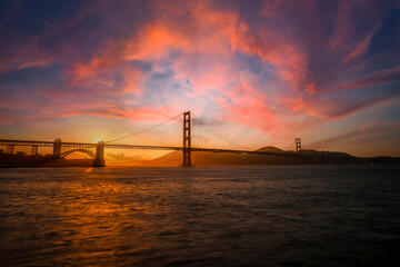 Gorgeous orange sunset with pink clouds over the Golden Gate in San Francisco, California. United...