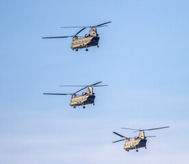 Three heavy lift helicopters in flight. Boeing Ch47 Chinook.