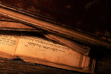 Old worn jewish books on open page of Makhzor with traditional Jewish prayer L'Shana Haba'ah...